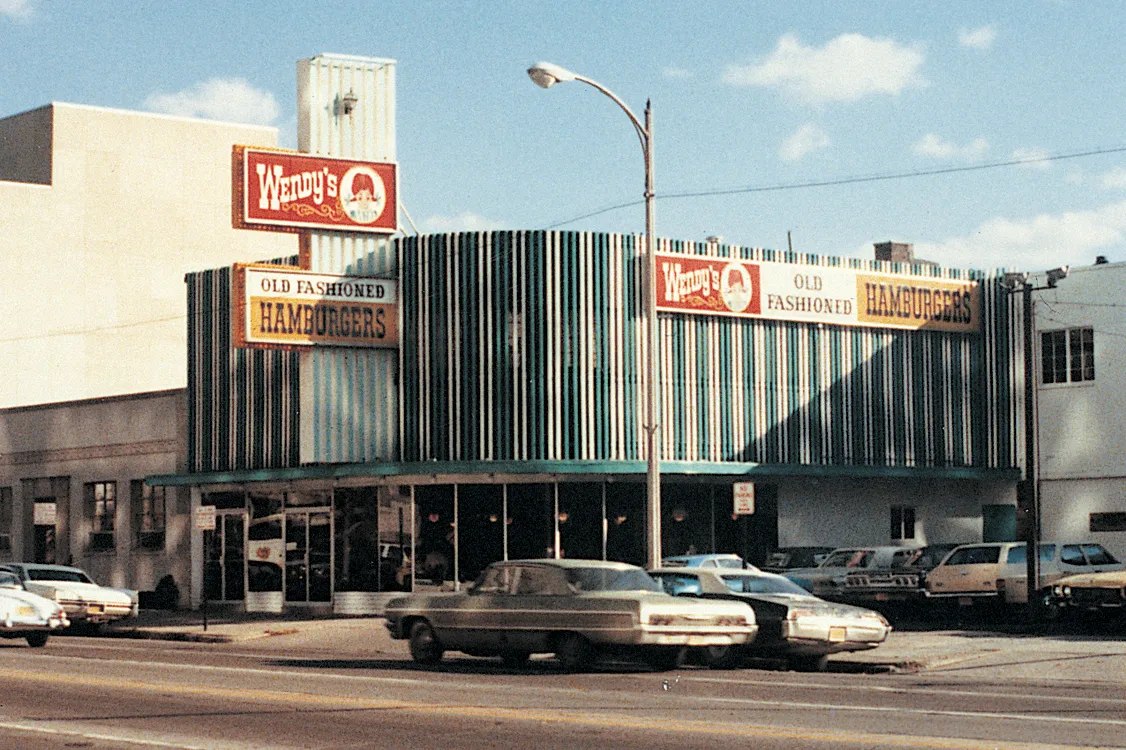 Historical photograph of the first Wendy’s restaurant and its early sign
